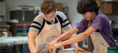 Two kids screenprinting