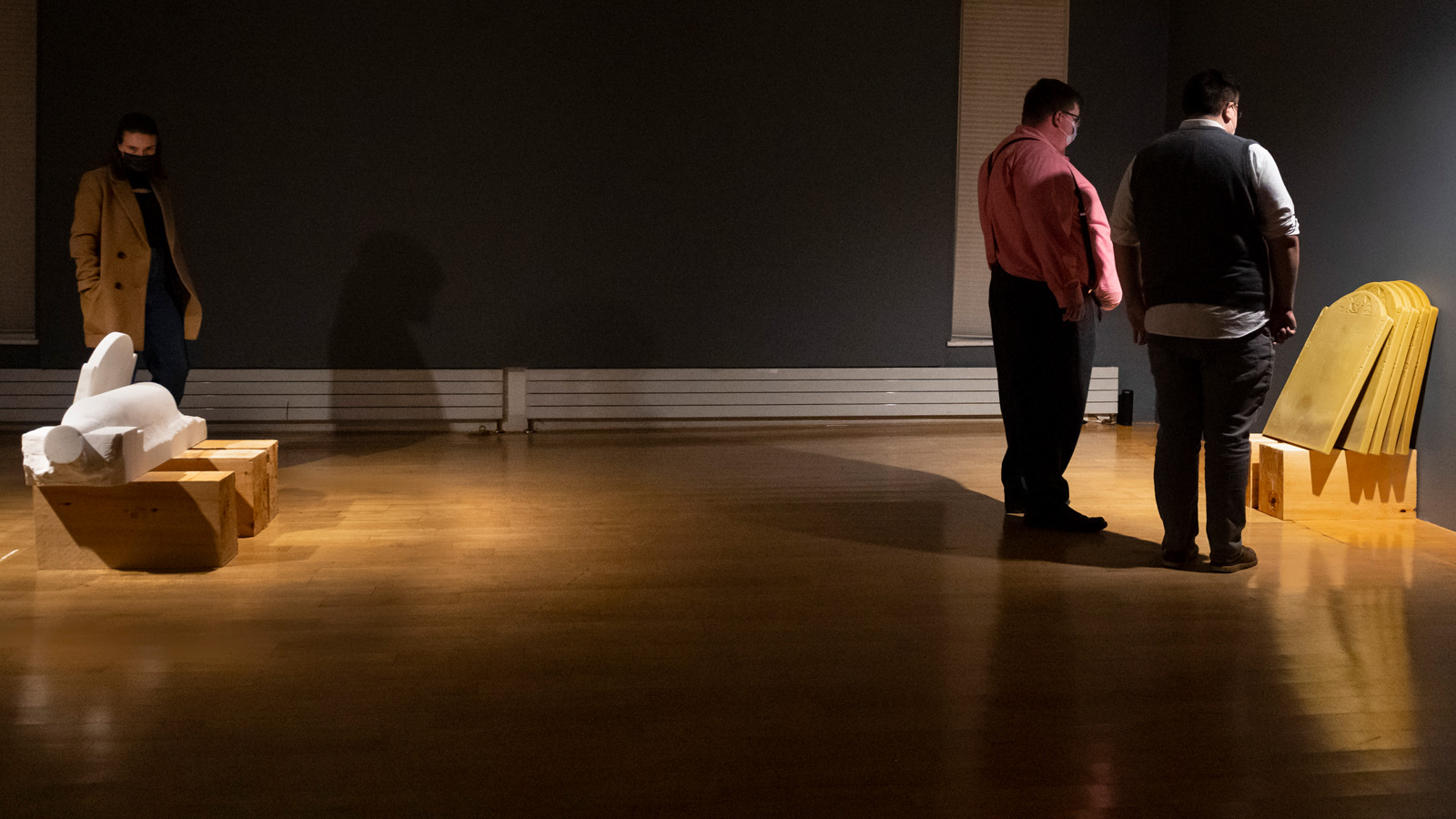 Objects of Empire BCA Center installation with people in gallery viewing marble carvings and beeswax castings
