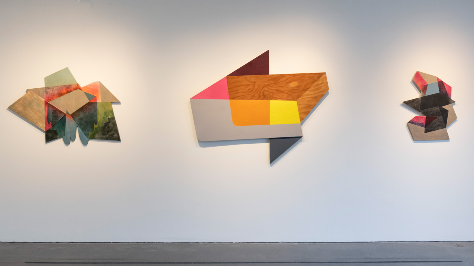 2-D Geometric, yet organic plywood printed works of art hangs on gallery wall