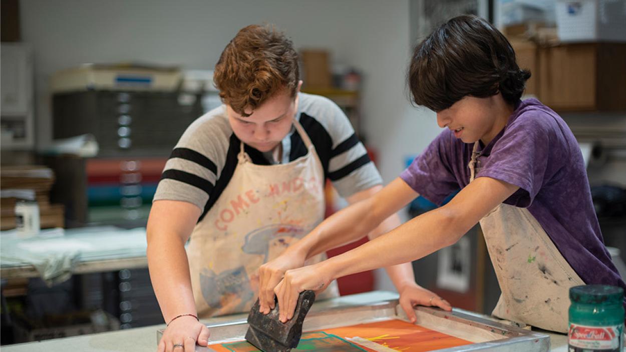 Two kids screenprinting