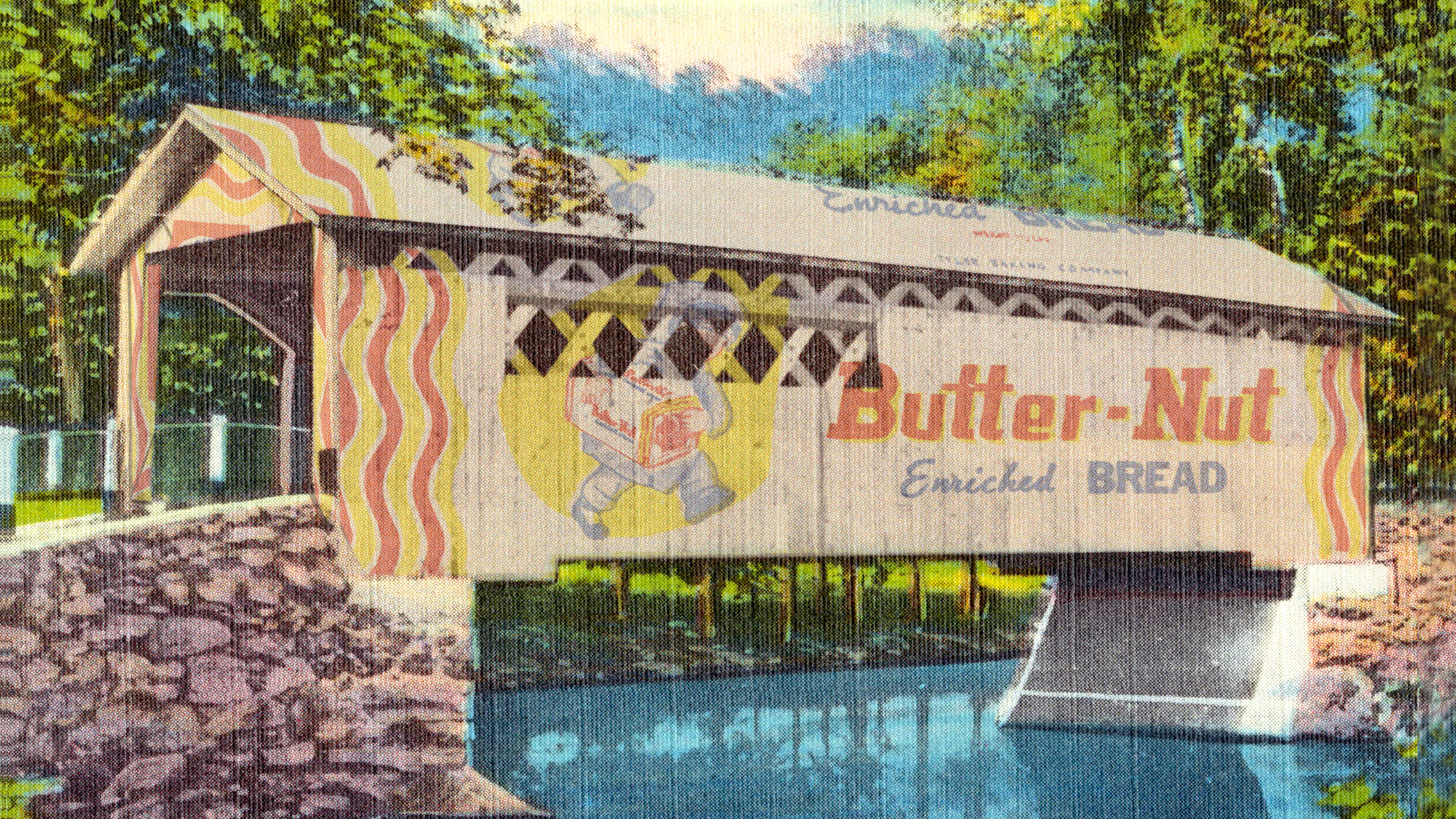A digital montage image that combines a 1930s colorized postcard of a wooden covered bridge with stone pilings that stretched over a blue creek with the branding of a package of bread overlaying the bridge that reads "Butter-Nut Enriched Bread"
