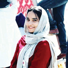 An image of a woman wearing a headscarf. 