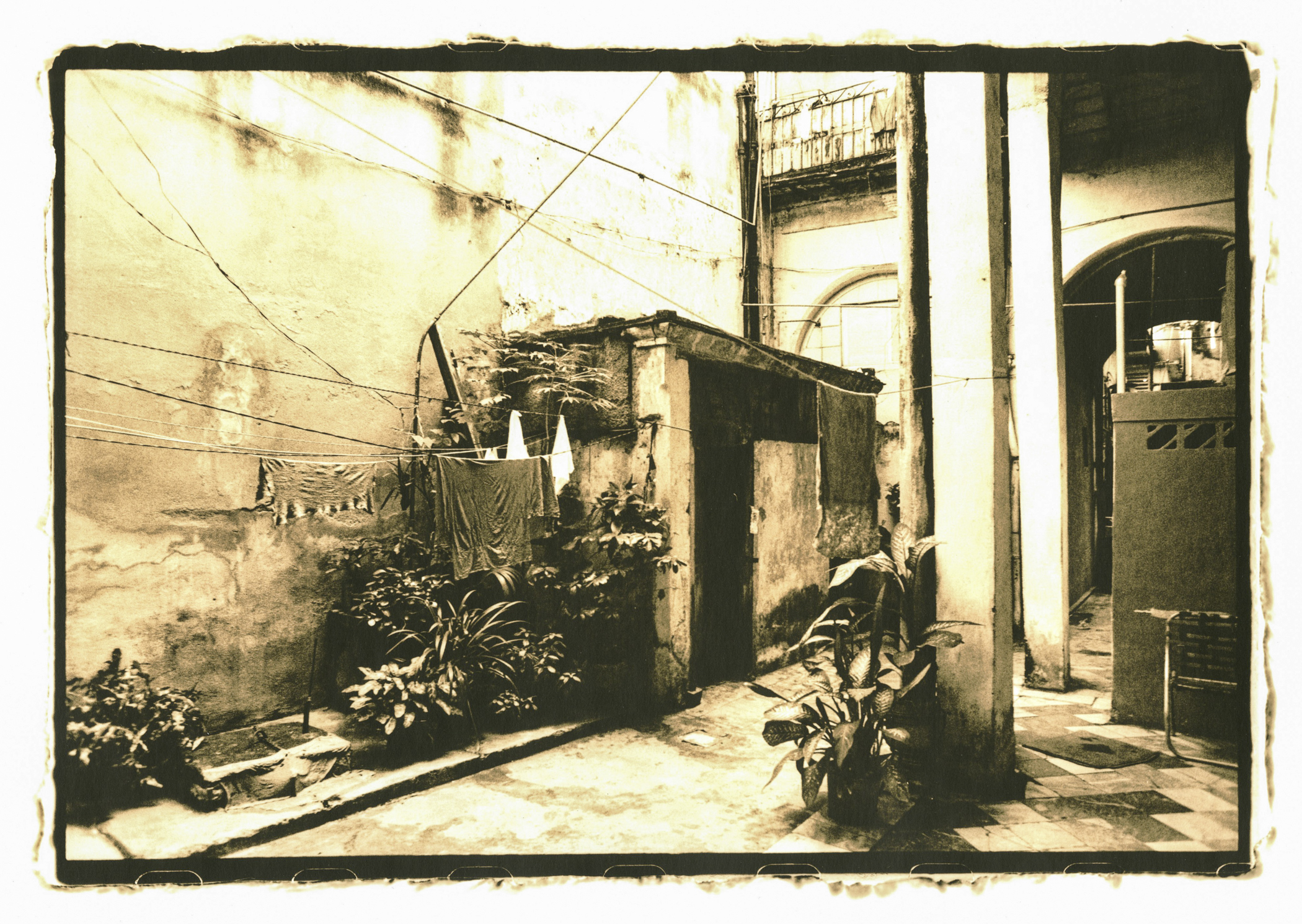A sepia toned image of a courtyard in Havana