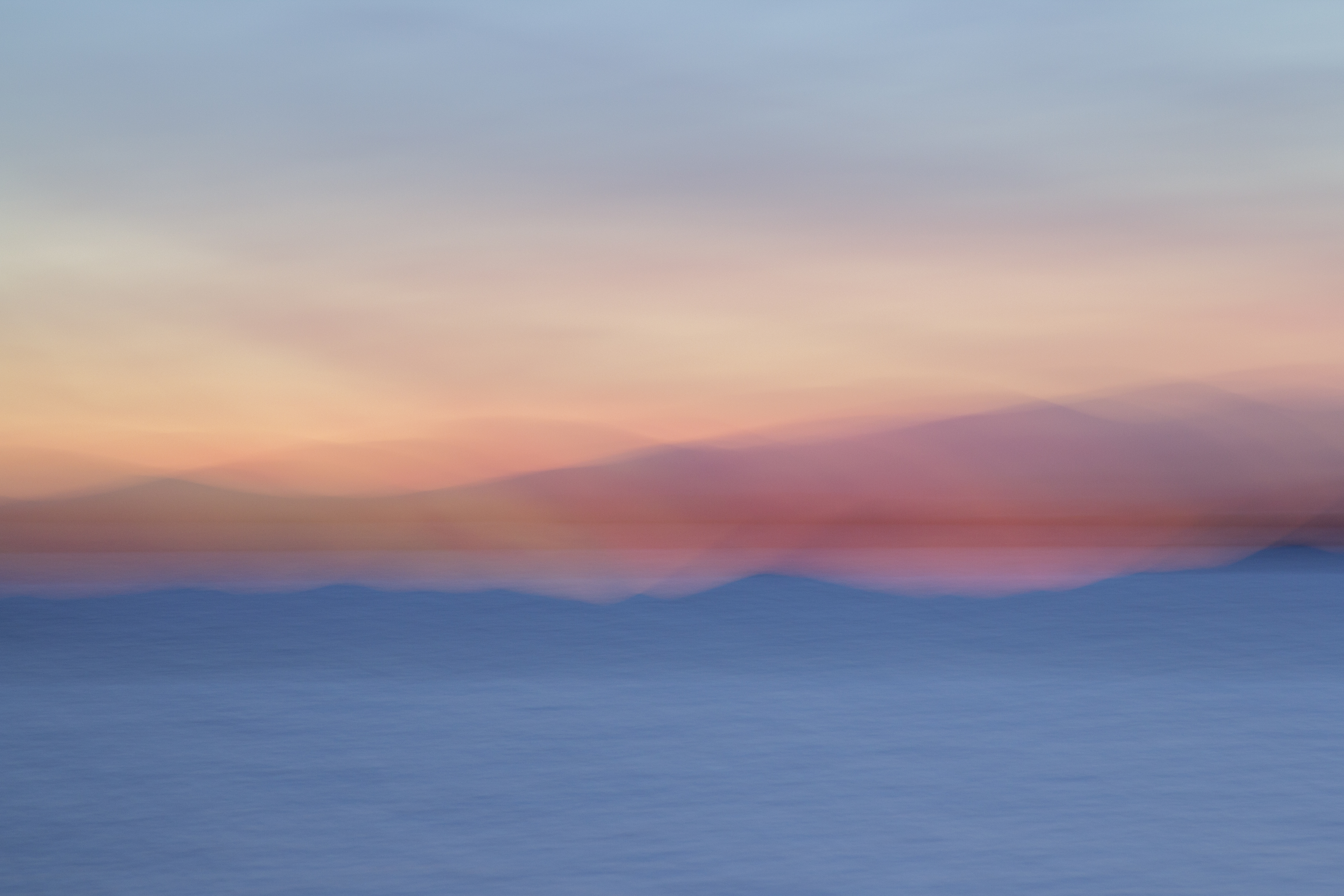 Long exposure photograph of Lake Champlain at sunset in pinks and blues