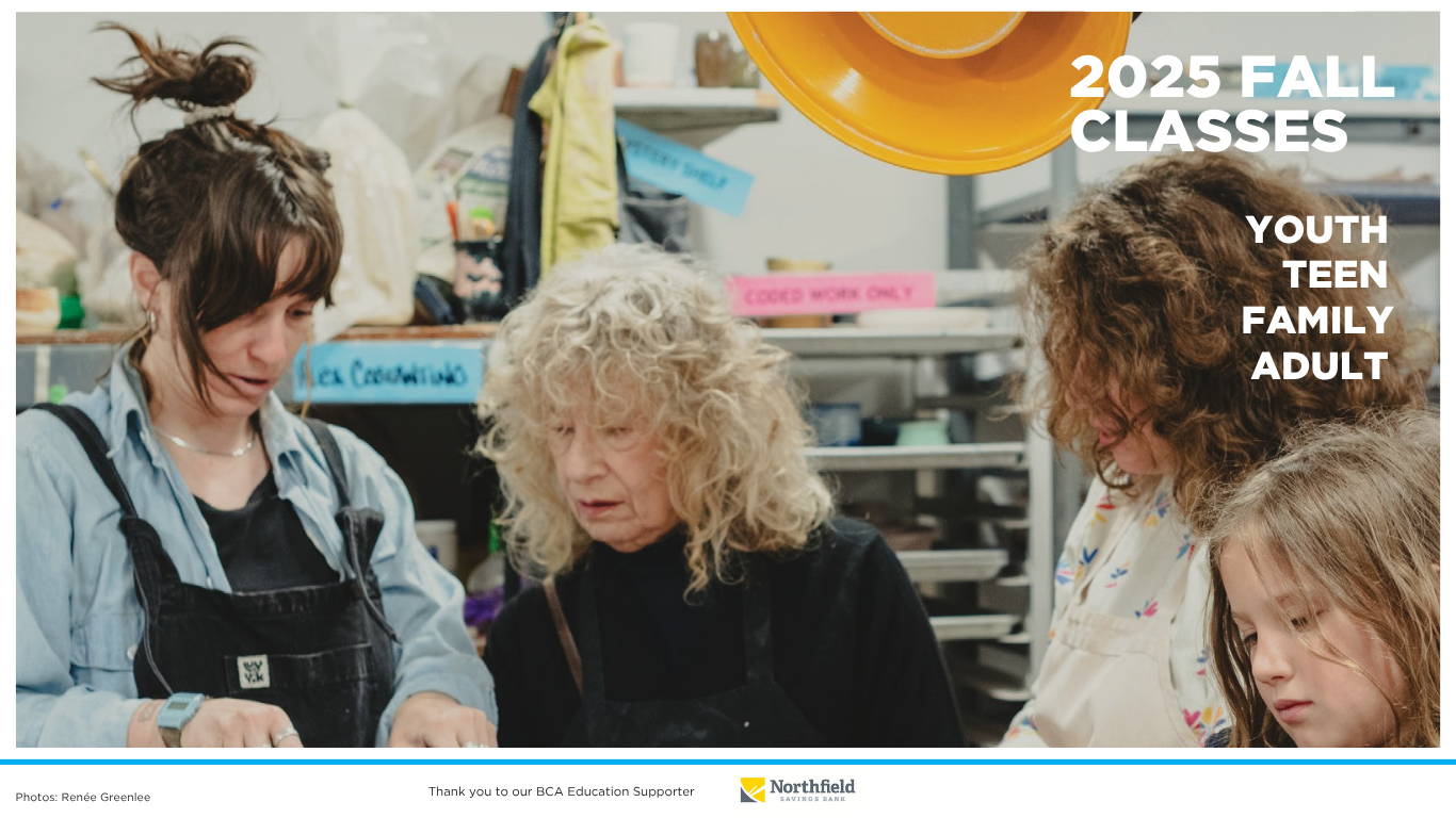People in an art class watching a demonstration.