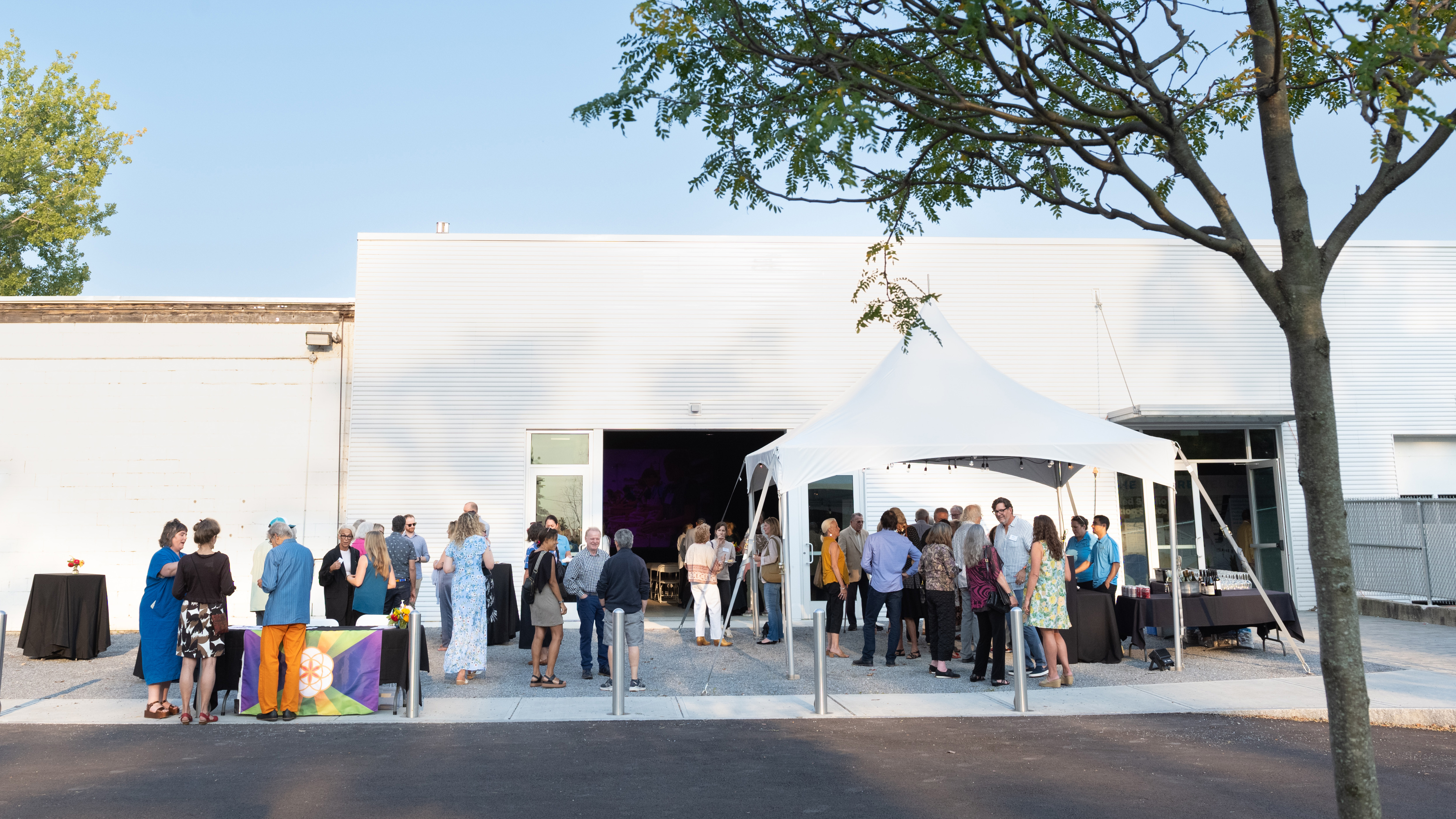 A photo of BCA's Community room and people outside at a gathering