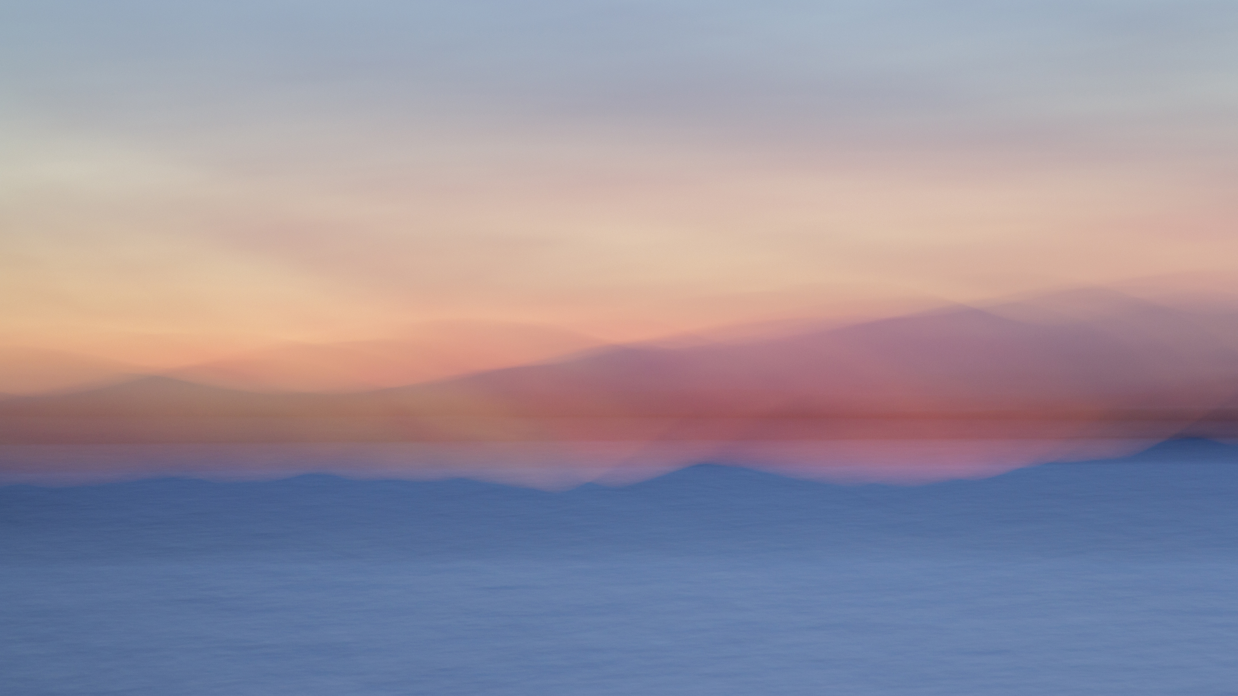 Long exposure photograph of Lake Champlain at sunset in pinks and blues