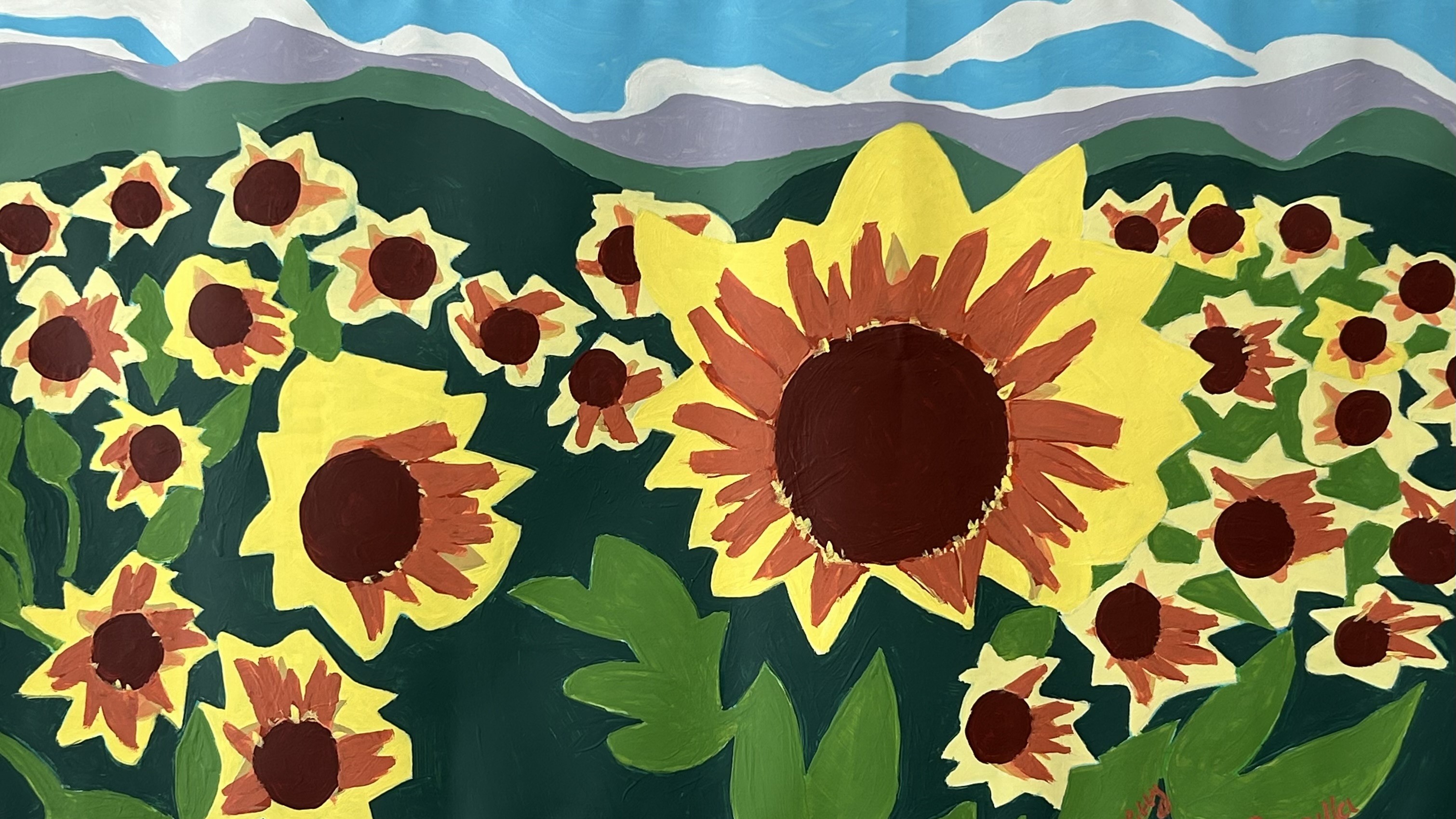 big bold painting of sunflowers in yellows, browns and greens with blue sky background
