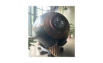 A round ball sculpture of a train engine