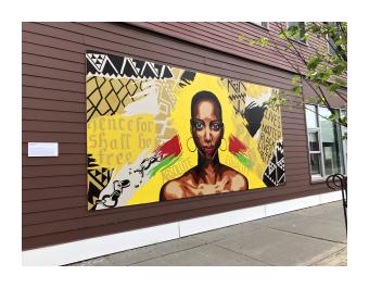 Mural of black woman with yellow background and text from the emancipation proclamation