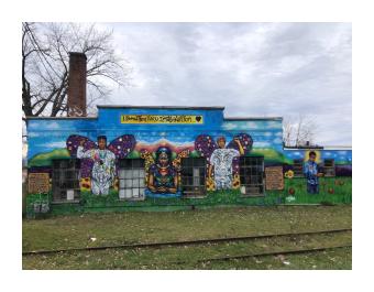 Mural of 4 youth on front facade of 399 Pine St.