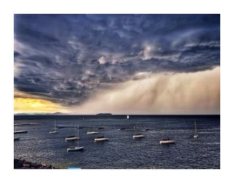 A photograph of a storm rolling in over the ocean 