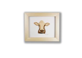 the use of wood to create an image of a frontal view of a cow's face