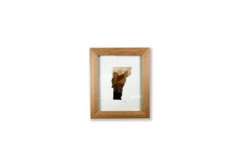 The use of wood to create the shape of the Vermont state filled in with dark to light gradient.