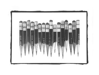 B&W photo of a line of well-used pencils.