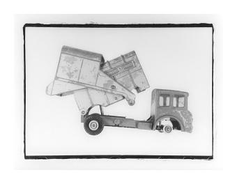 B&W photo of a toy dumptruck.