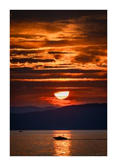 Photograph of a sunset on the lake in blues and oranges. 