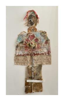 Mixed media portrait of an abstract figure in earthy browns and reds. 