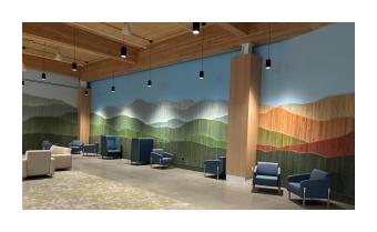 a photo of an at installation Vert Mont by Ben Butler that is comprised of painted reclaimed boards that are assembled to depict the green mountains 