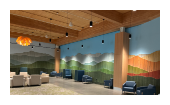 a photo of an at installation Vert Mont by Ben Butler that is comprised of painted reclaimed boards that are assembled to depict the green mountains 