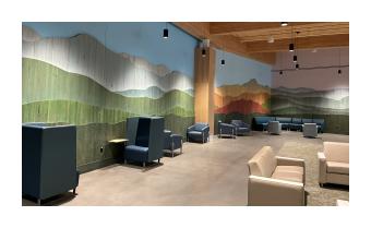 a photo of an at installation Vert Mont by Ben Butler that is comprised of painted reclaimed boards that are assembled to depict the green mountains 