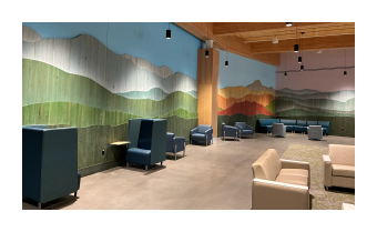 a photo of an at installation Vert Mont by Ben Butler that is comprised of painted reclaimed boards that are assembled to depict the green mountains 