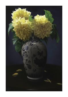 Oil still life of a decorative vase filled with yellow flowers. A few petals lay on the table below.