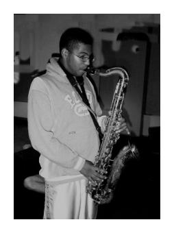Oil of a man playing the saxophone in black and white.