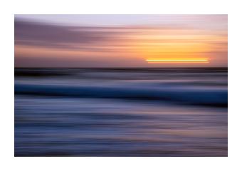 Photograph of a motion blurred sunset on the water.