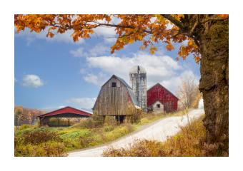 Photograph of a red barn & farm during fall. 