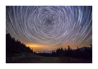 Photograph depicting the spinning and circular motions of the stars in bright blue contrast.