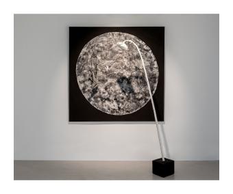 Multimedia piece depicting a textured moon on a black canvas with a sunflower leaning in front of it. 
