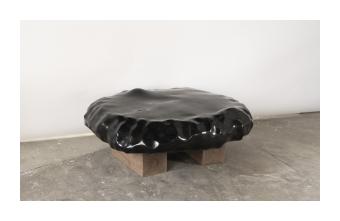 Basalt black table with slight internal concave. 