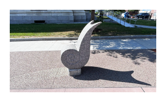 a photograph of Magnus, a statue of a stone snail