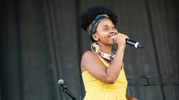 Ferene Paris Meyer holding a microphone smiling