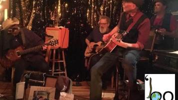 'Bo performing on stage with gold streamers in the background.