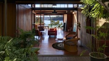 A contemporary home frames an architectural view of a bay of water