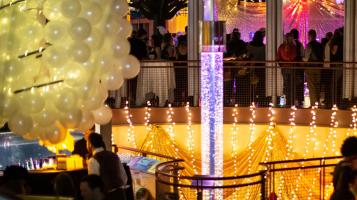 patrons enjoying a glamorous New Year's Eve party inside a decorated Echo Leahy Center