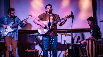 The trio playing on an amazing light stage.