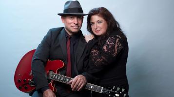 Twangtown standing in front of blue wall dressed in vintage attire