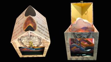 Two small multi colored collaged boxes in the shape of houses against a black background
