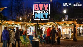 BTV Winter Market, BCA Love Burlington over a photograph of an outdoor market at dusk, with people milling about wooden sheds decorated with evergreen garlands and twinkly lights and blue and green adirondack chairs around firepits
