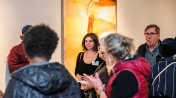 People smile during an opening reception at the BCA Center.