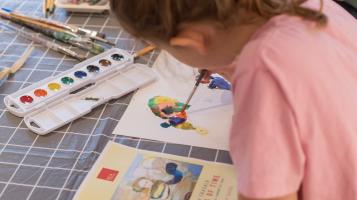A young student creates art at Family Art Saturday.