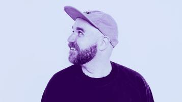 man with a hat on with a blue and purple filter around him