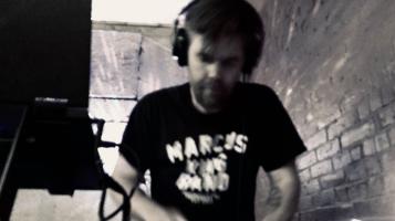 Black and white image of dj that is blurry