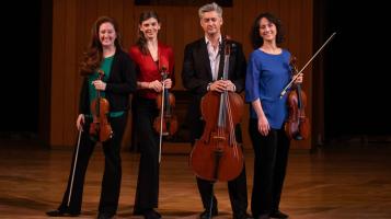 4 People on a stage with instruments