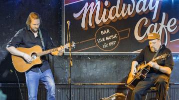 two people playing strings at the midnight cafe