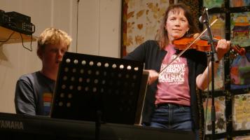 a woman and child playing music