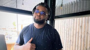 person standing with thumbs up and shades on